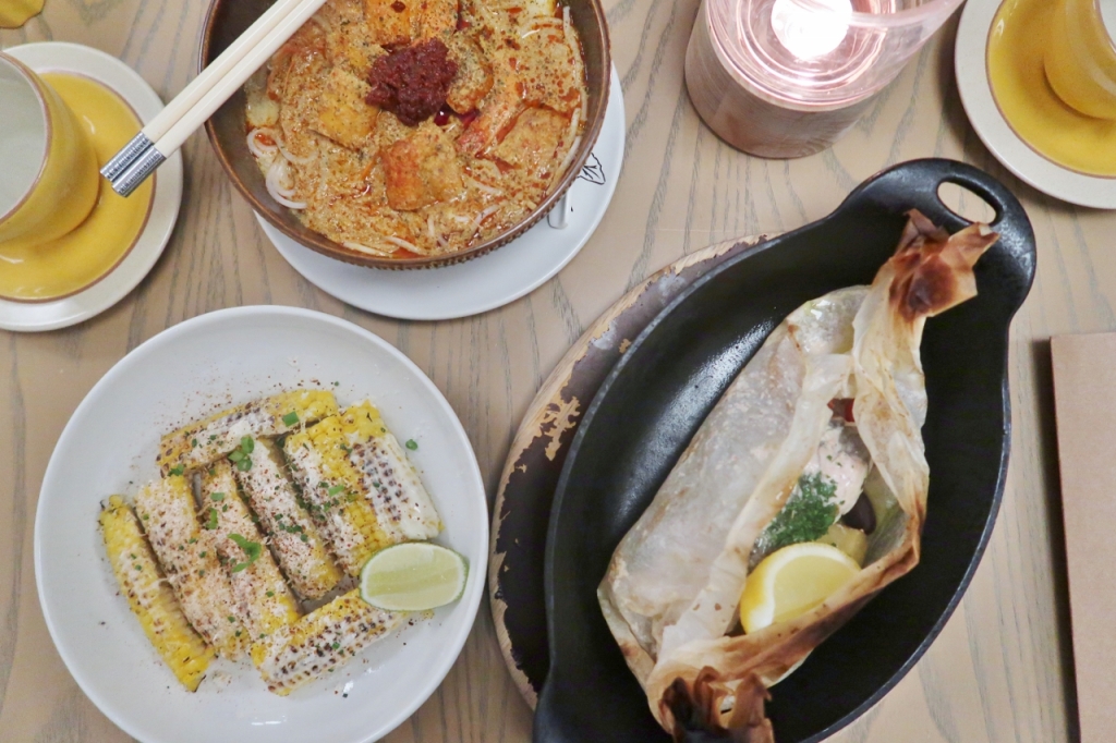 Barramundi En Papillote, Auntie's Laksa and grilled corn from The Green Oven restaurant at Andaz Hotel