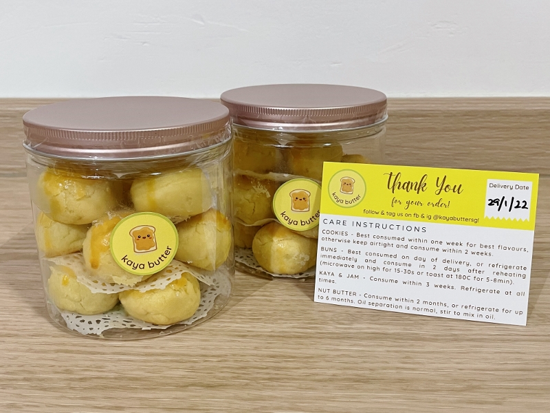 Two tubs of handmade pineapple tarts from Kaya Butter bakery